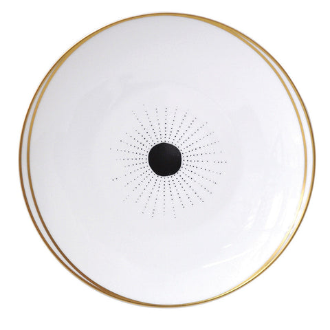 Designed by Paris-based interior decorator Sarah Lavoine, Bernardaud's Aboro coupe salad plate is crafted of white porcelain detailed with a black circle, pin-dot design, and goldtone rim.