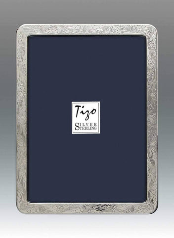 Tizo Design's picture frame is crafted of polished sterling silver. Made in Italy, this luxurious home accent has a wooden easel back and can be displayed vertically or horizontally. .925 Sterling silver frame Handmade in Italy, holds vertical and horizontal photos Stunning frame with solid sterling silver High Quality Polished wood backing